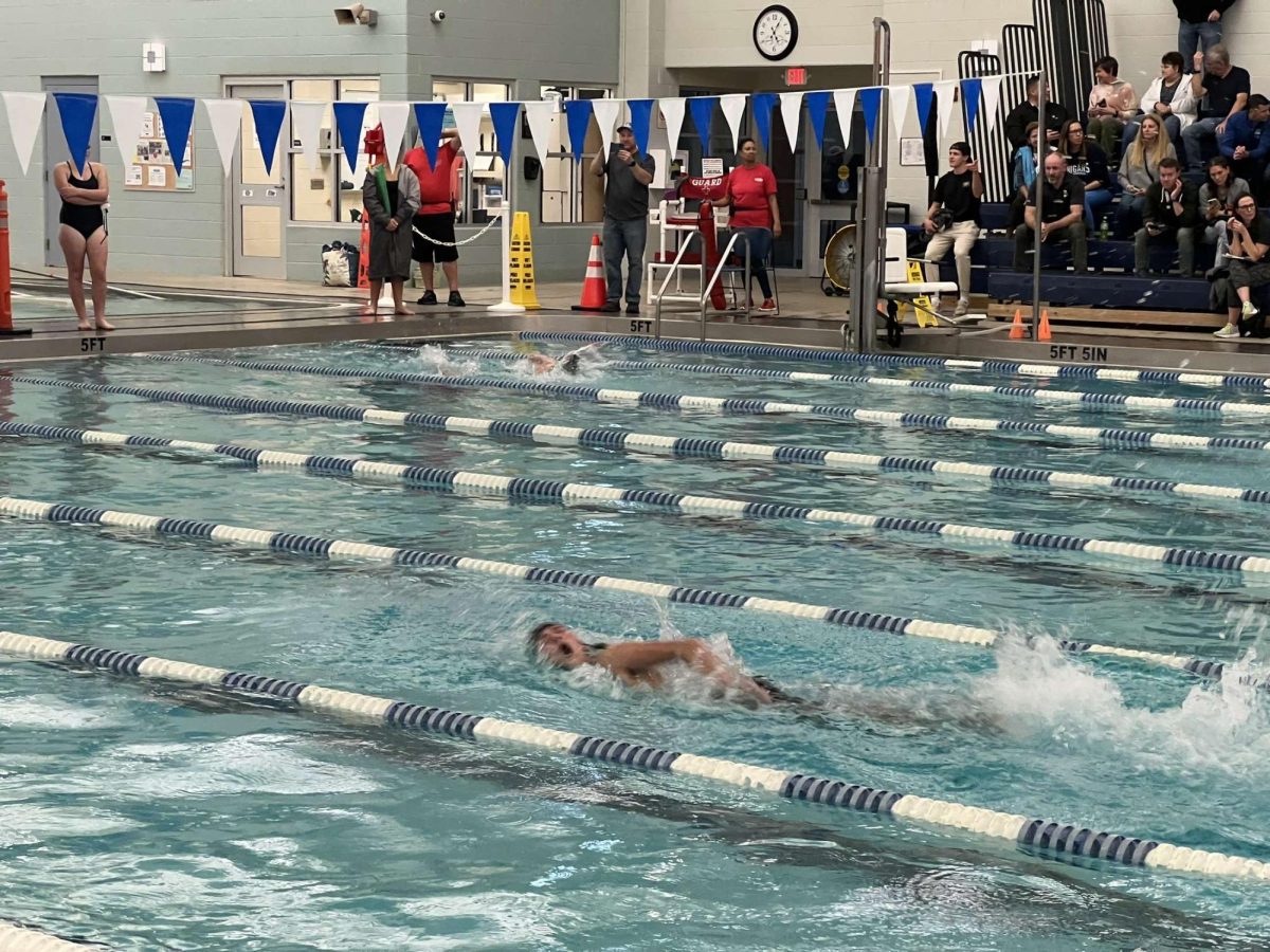 Swimmers comes up for breathe during freestyle.