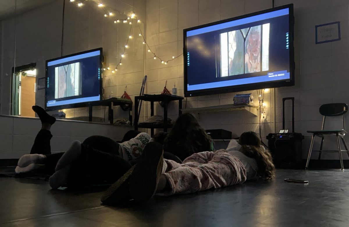 Juniors Lilly Madibo and Jazmine Roberts along with Freshman Olivia Shuchart and Senior JaNaih Davis sit watching a movie on the last day of classes before exams. 