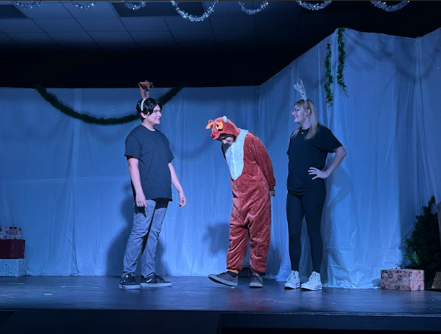 Freshman Isaac Sanchez as Donner, Freshman Penelope Heyden as Mrs. Donner, and Junior Jacob Sanchez as Rudolph as they discover Rudolph's shining nose. 