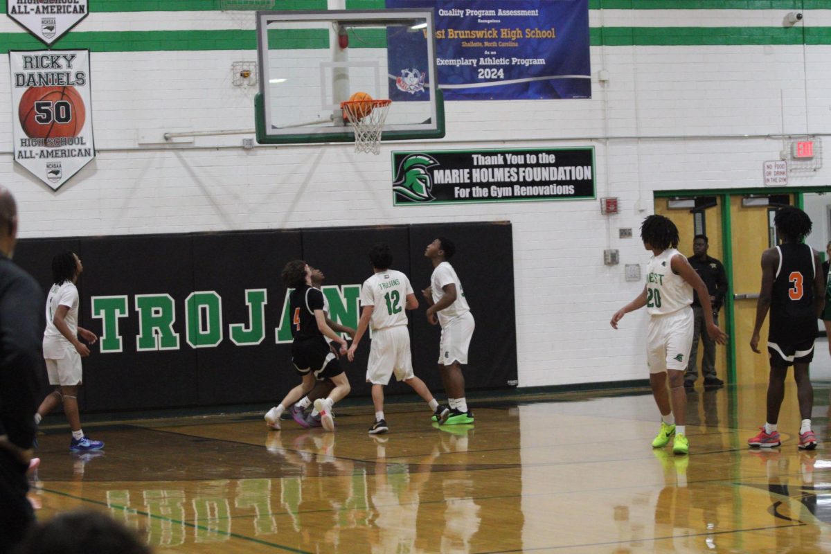 Both teams eager to get the ball after the basket.