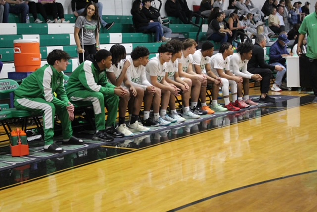 JV men team watching their players play.