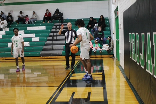 Sophomore Kameron Metters, Receiving the basketball from a ref to throw in to sophomore Motashi Lance. 