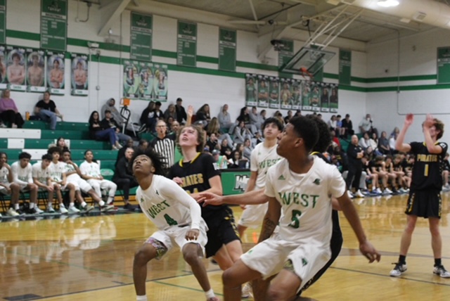 Sophomores Tylee Hammond and Tyrone Williams, blocking their defenders from getting rebound.