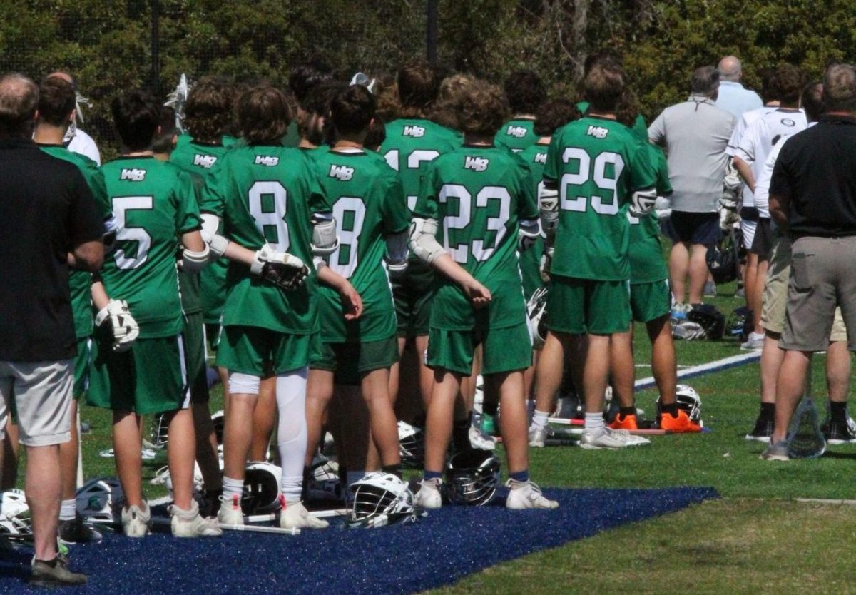 Before the game began, both teams stood together to listen to the playing of the National Anthem.