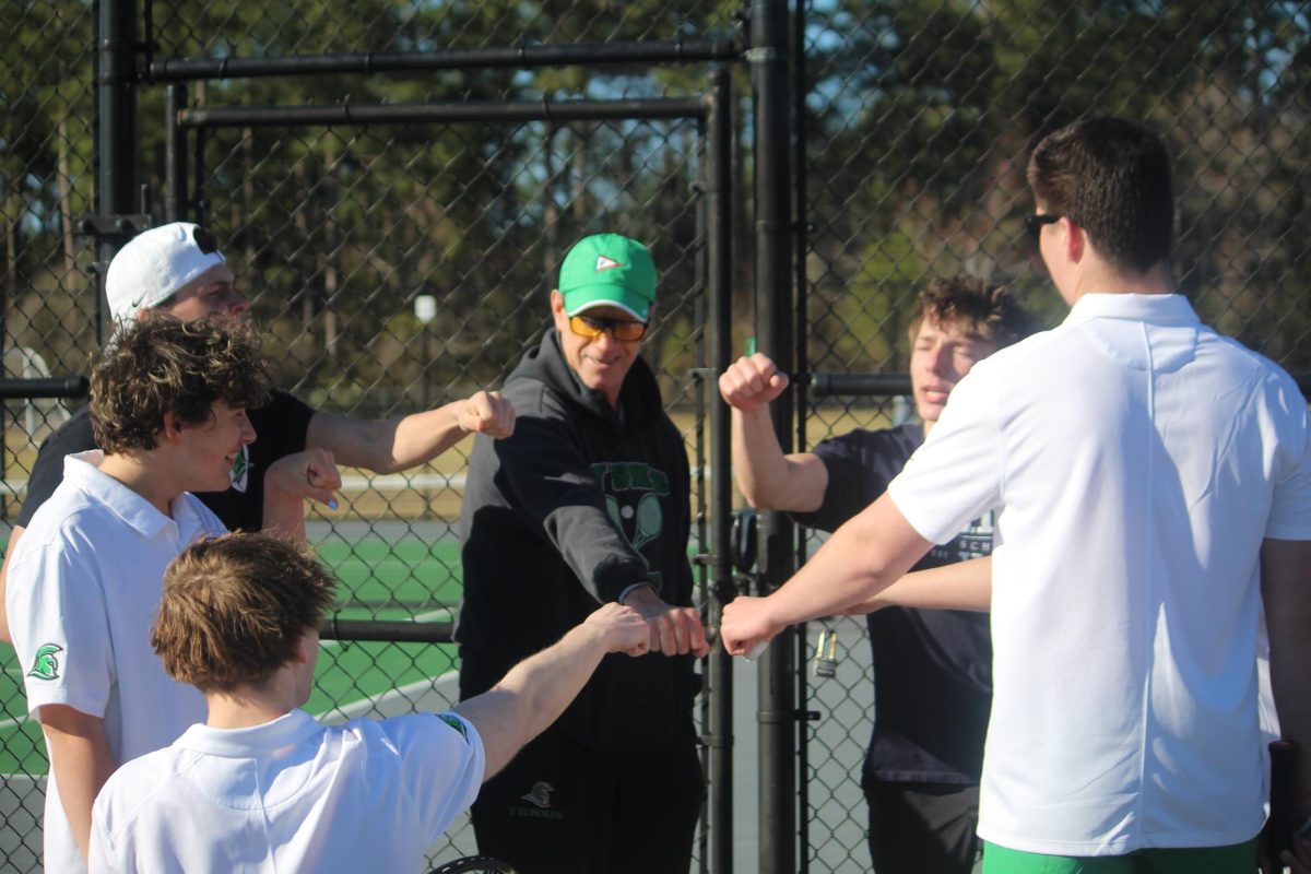 Coach Scott Mehalick and players gathered for a group cheer before playing.