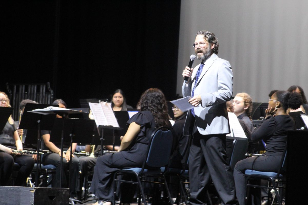 Mr. Seip discussing the next song that their band will be playing.