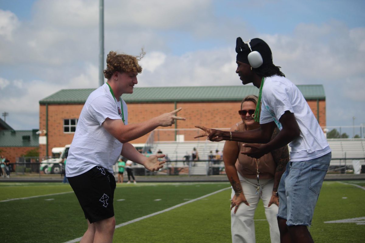 Students have a tie playing rock, paper, scissors.