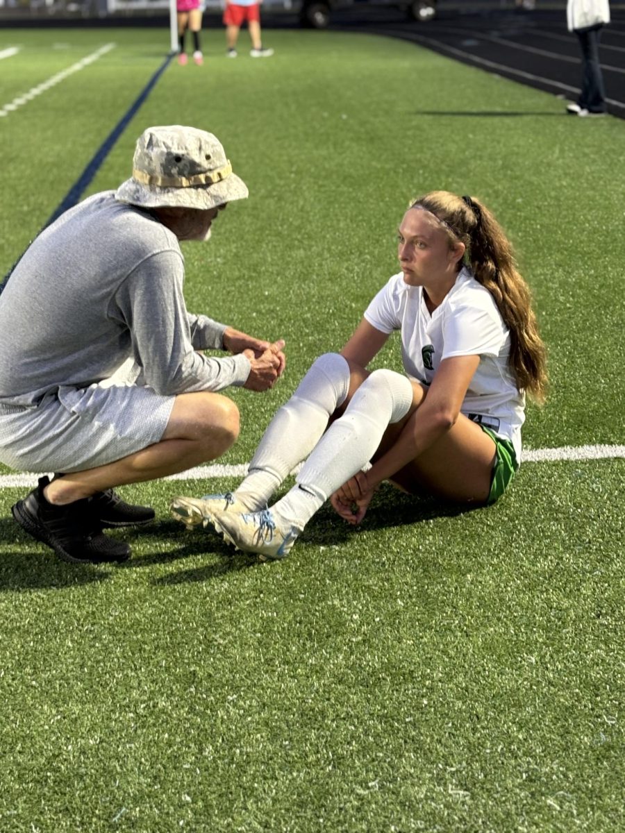 Coach Mike Adcock giving a pick me up talk to Layla Thomas