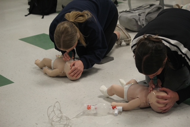 Jayla Alegandro and Erin Bohrer preforming CPR