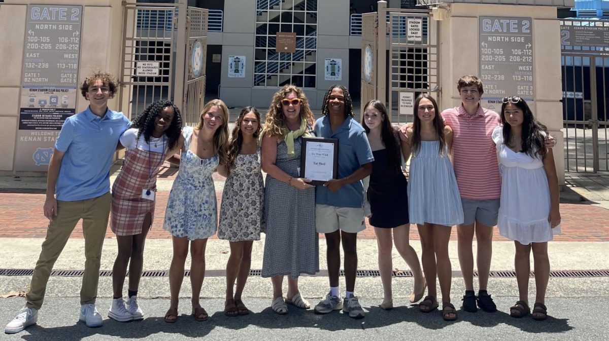 The class poses for a photo with the beloved Tar-Heel award in front of Kenan stadium.  