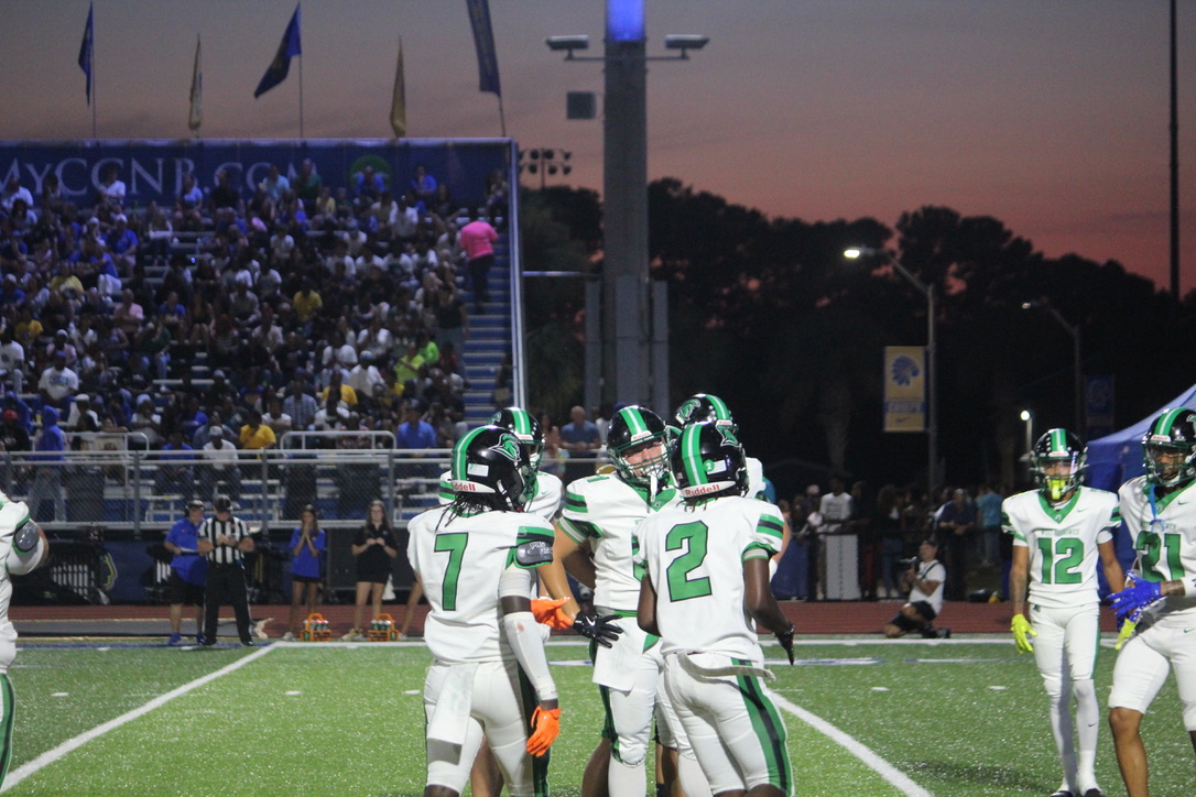 Trojans huddle together mid game. 
