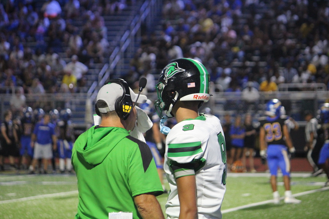 Coach talking to player about the game.