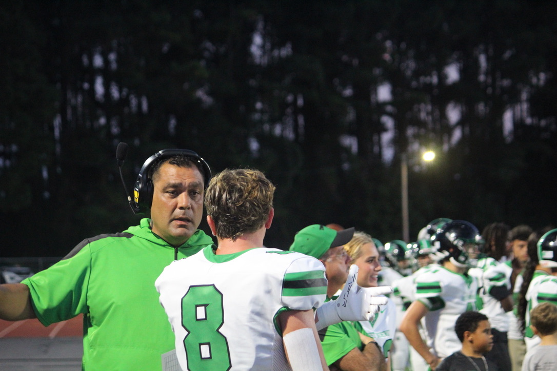 Coach giving player a pep talk after a bad play.