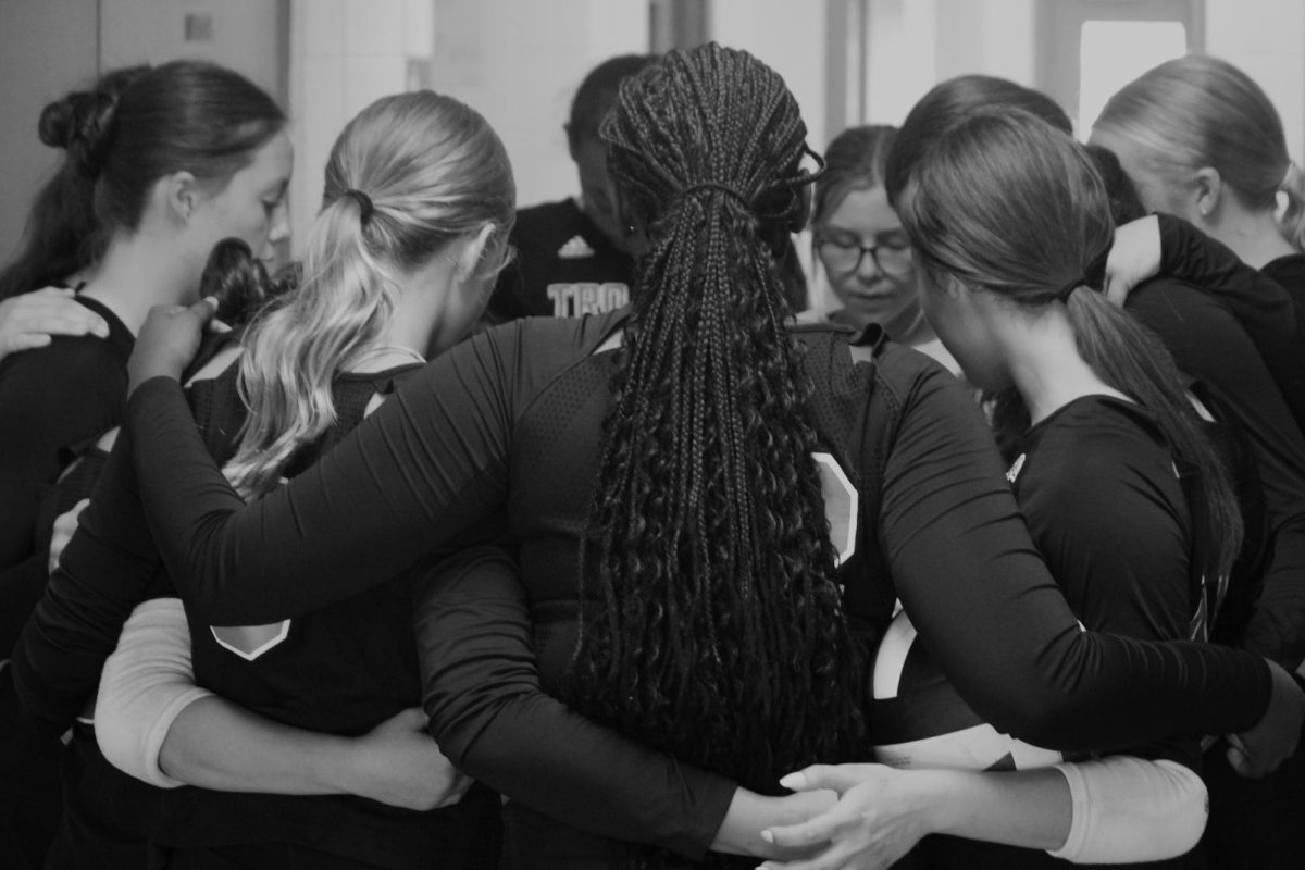 Team prayer in the hallway before the whistle is blown to start the game. 