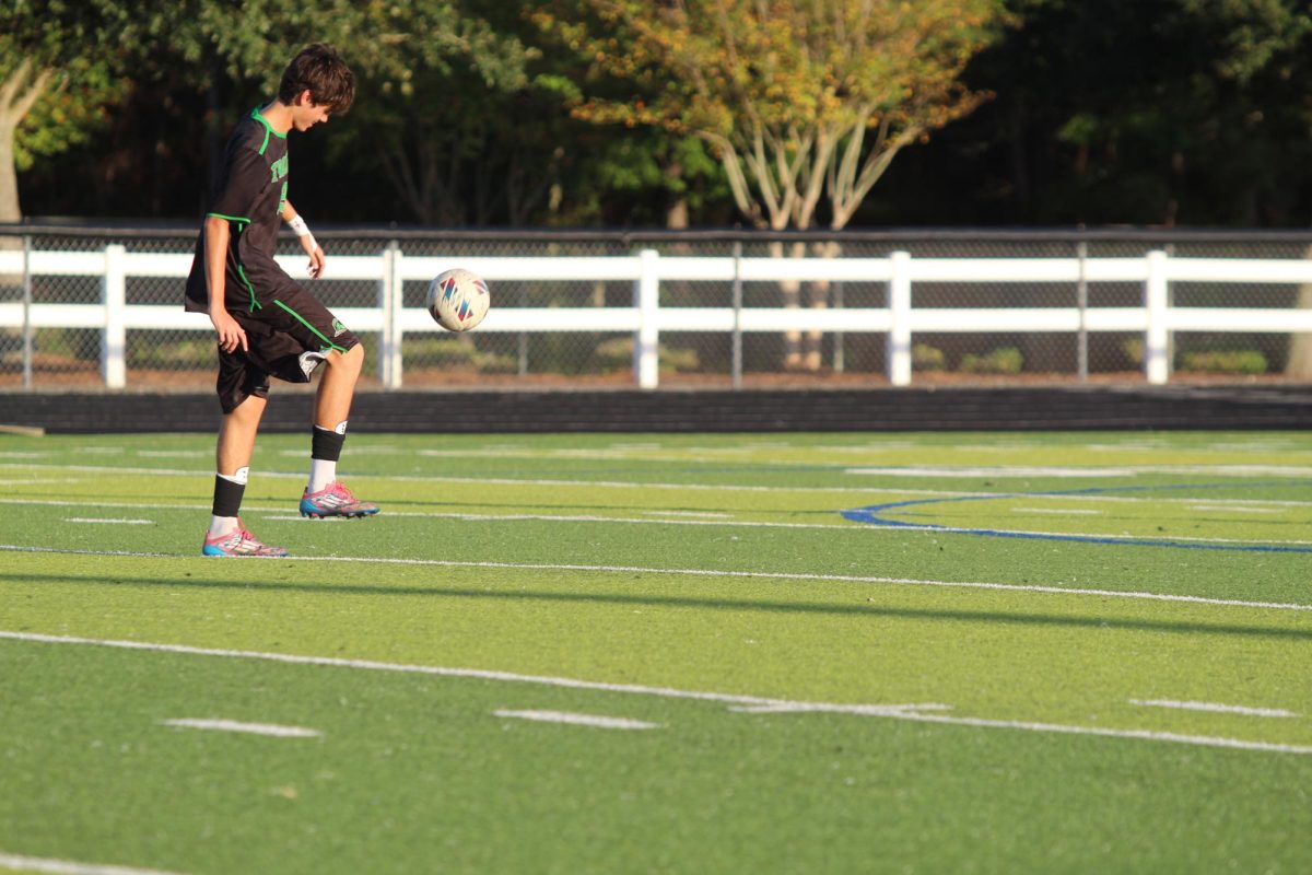 ____ kicking the ball to warm up before the games starts.