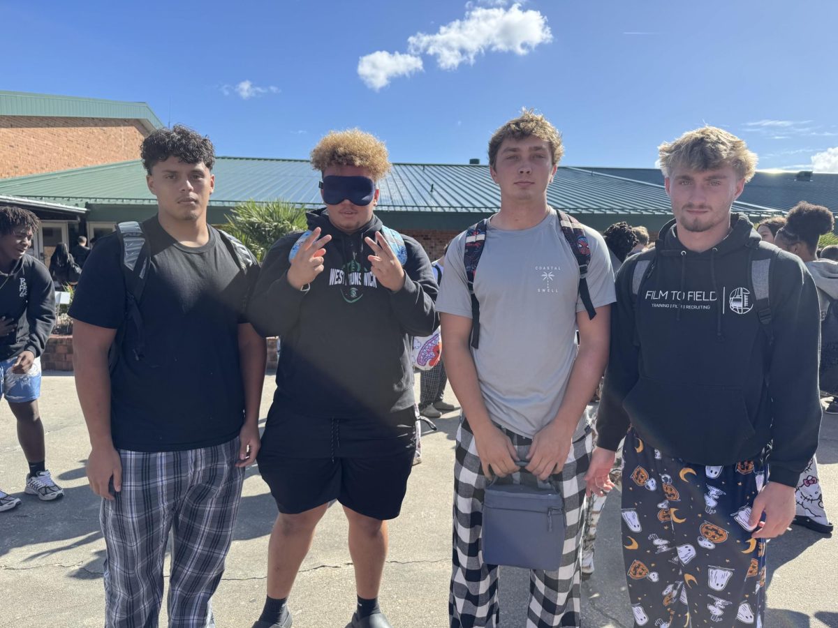 Juniors Christian Mendoza, Joshua Walton and Seniors Josiah Sneed, Jude Surgiao, posing for spirit week.