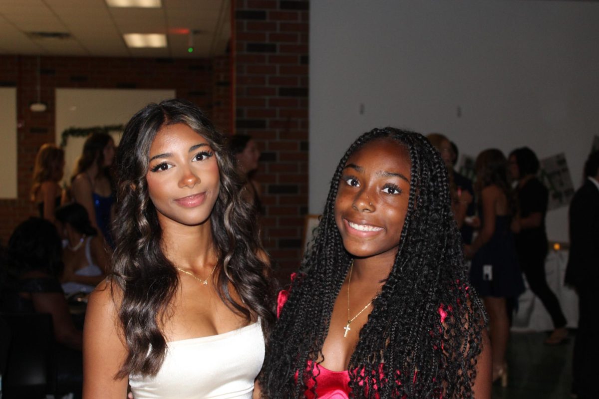 Sophmore Celine Tendo and freshman Zoei King posing for their picture .