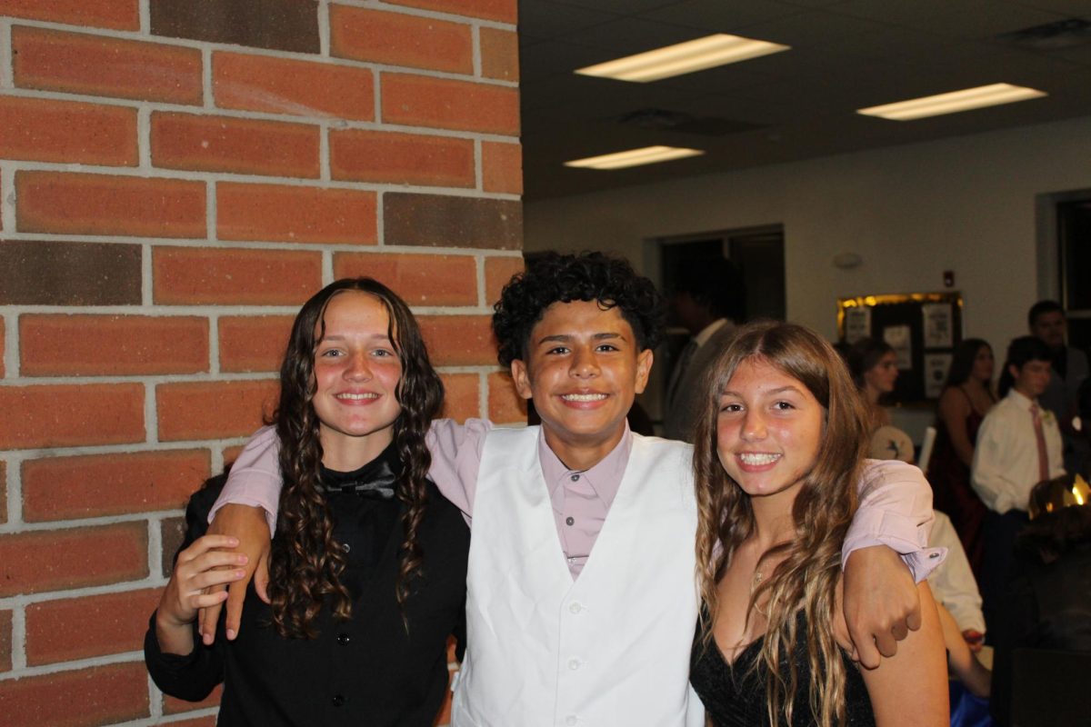 Freshmen Greer Kost, Lexi Beers and Dustin Rodriguez smiling for the photo. 