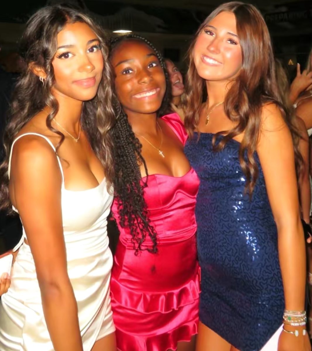 Sophomore Celine Tendo, freshman Zoei King and senior Teagan Cossey posing for the camera.