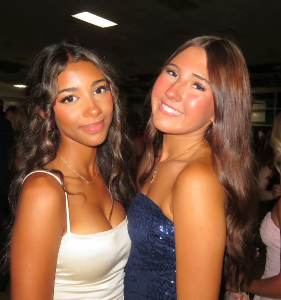 Freshman Celine Tendo and senior Teagan Cossey smiling for their picture. 