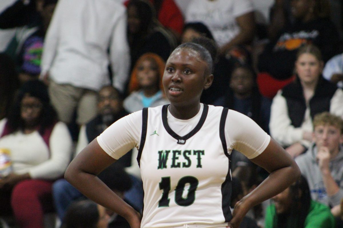 Tameya Thomas smiling to her coach after an accomplishment on the court. 
