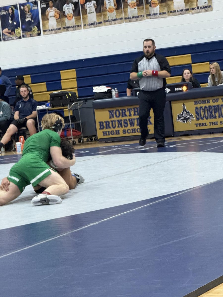 Senior Isaac Holden taking action on the mat.