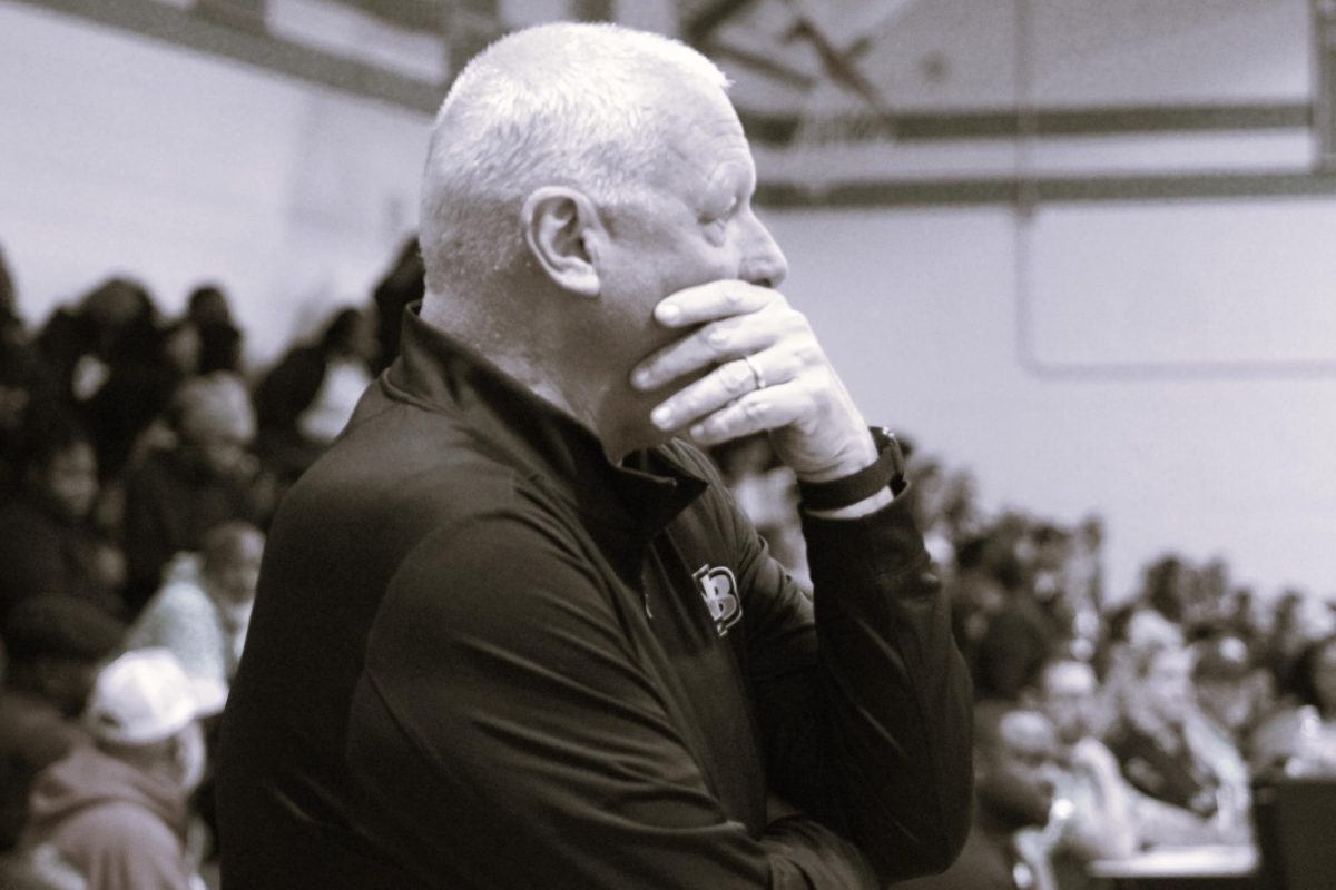 Coach Everette watching his players work the court. 