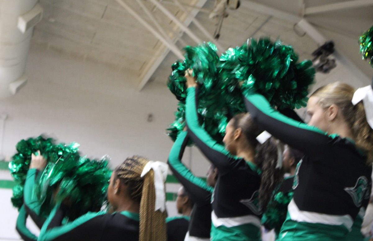 Cheer team rooting for Trojan while shooting a free throw.