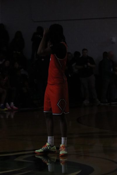 Ny'zion Ballard standing at the center of the court.
