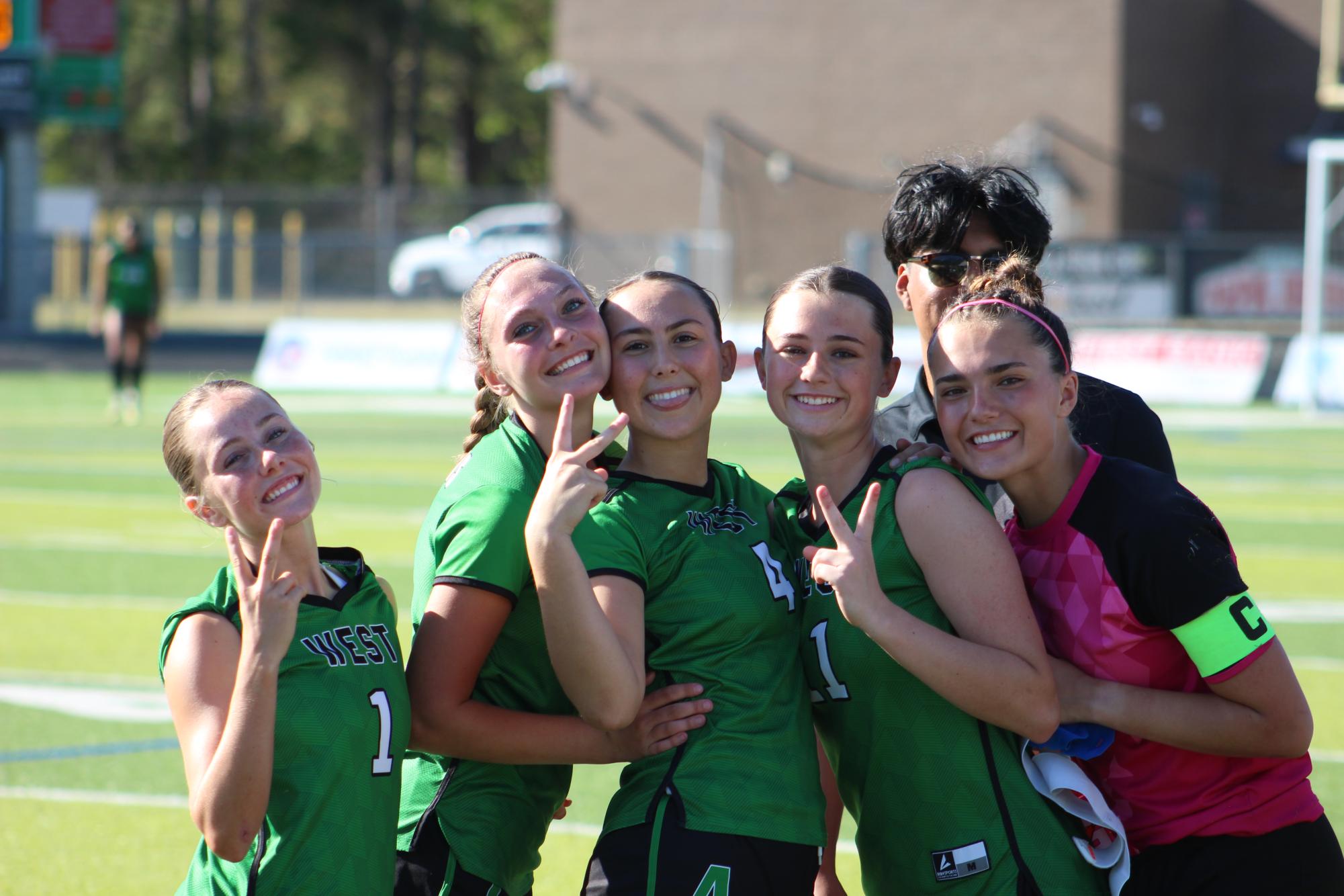 The lady Trojans are excited for the game to start.