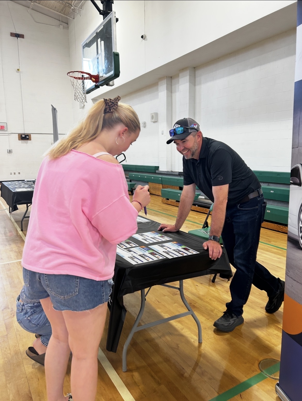 transportation station with student talking to SECU employee.