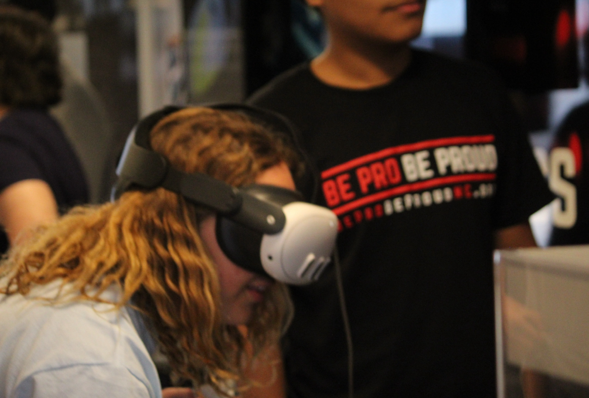 Students engaged while using a virtual reality headset.