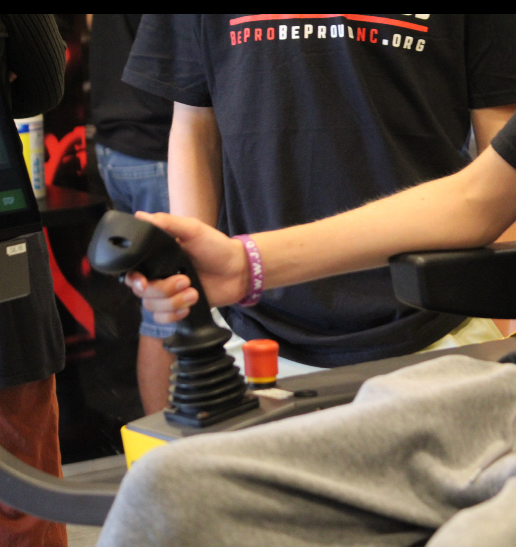 Student testing out the controls for the forwarder simulator.